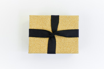 Gift box in gold duo tone with golden satin ribbon and bow separated