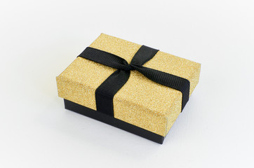 Gift box in gold duo tone with golden satin ribbon and bow separated