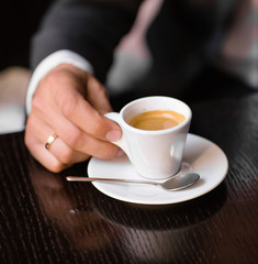 man holding hot cup of coffee