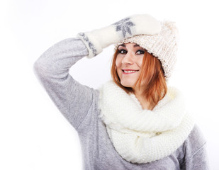 Young girl in a woolen hat and scarf. A girl dressed warmly. Winter cold. Portrait of a girl with big eyes on a white background
