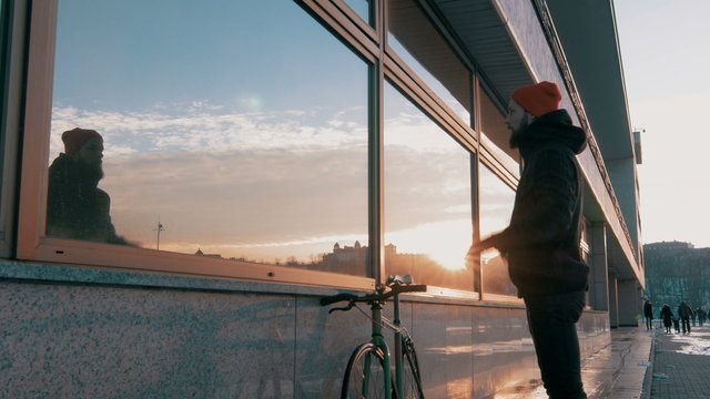 Guy riding fixed gear bike on background of the port, 4k