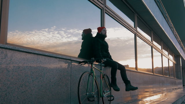 Guy riding fixed gear bike on background of the port, 4k