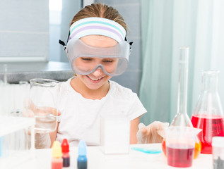 little girl with flasks for chemistry