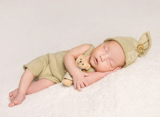 sweet newborn baby sleeping in costume and hat