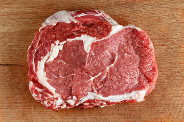 Fototapeta premium Raw ribeye steak on a cutting board