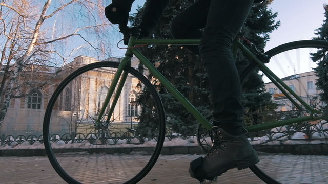 Guy riding fixed gear bike in city centre,super slow motion