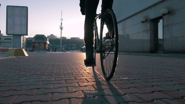 Guy riding fixed gear bike in marine station, slow motion