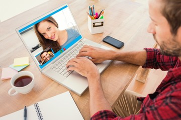 Composite image of creative businessman typing on laptop