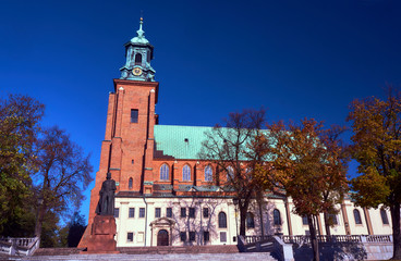 Statue and cathedral church in Gniezno, Poland.