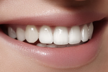 Beautiful smile with whitening teeth. Dental photo. Macro closeup of perfect female mouth, lipscare...