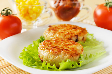 Meat patties on a white plate.
