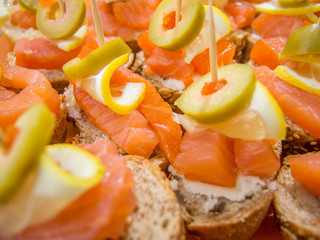 Fototapeta na wymiar mini bruschetta with salmon stuffed olives and lemon slices