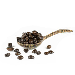 coffee beans in olive wood spoon, isolated on white