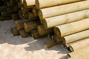 cylindered logs on the sand