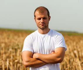 Young farmer in corn field