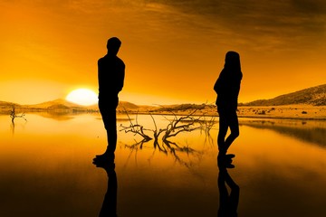 Composite image of sad couple standing back to back