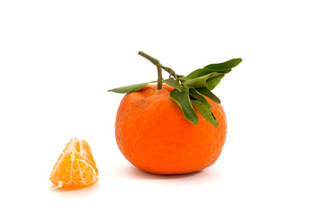 Fresh tangerine with green leaves isolated on white background