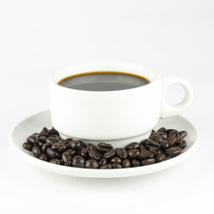 white cup with coffee beans, isolated on white background