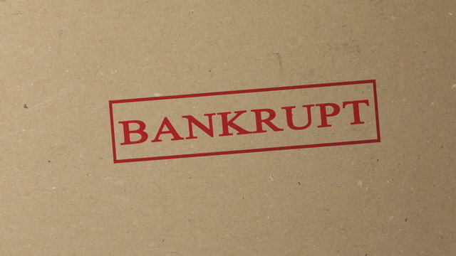 Bankrupt red ink stamp on documents folder