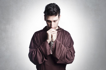 young friar praying