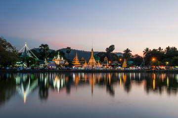 Reflection of Wat Chong Kham in the lake after sunset