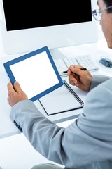 Businessman using his tablet 