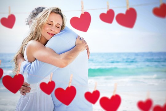 Composite image of happy couple hugging each other