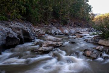 Naklejka na ściany i meble creek flowing over the rocks
