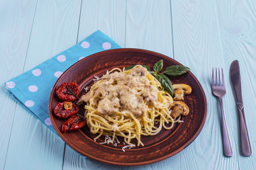Spaghetti with mushrooms and sun dried tomatoes in cream sauce.