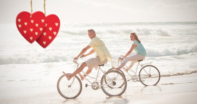 Composite image of happy couple on a bike ride