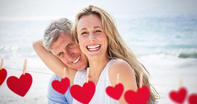 Composite image of happy couple laughing together