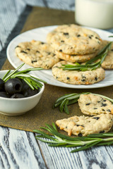 Cookies with cheese, olives and rosemary on napkin