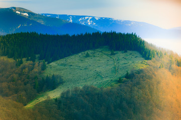 Landscape in the mountain:snowy tops and green valleys.