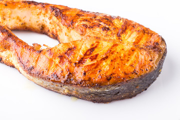 Grilled salmon steak isolated on white plate. Restaurant fish menu background