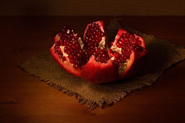 The opened fruit of ripe pomegranate on a sacking