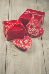 Two hearts hanging on wooden background