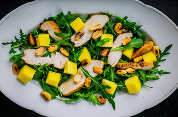 Chicken salad with mango, arugula, and peanuts
