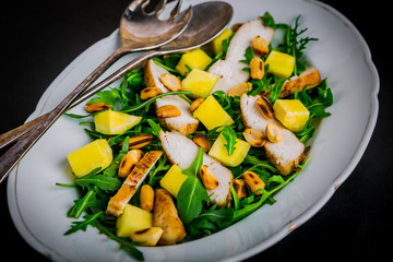 Chicken salad with mango, arugula, and peanuts