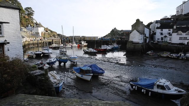 English harbour Polperro Cornwall South West England UK out of season in winter with boats at low tide