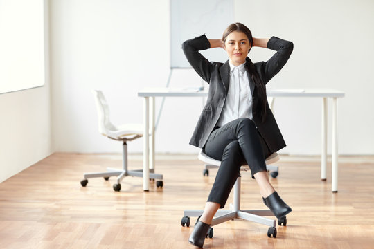 Portrait Of Beautiful Business Woman Sitting On Chair In The Off