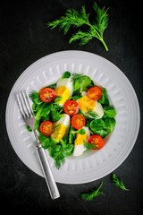 Fresh green salad with lamb's lettuce, cherry tomatoes and eggs