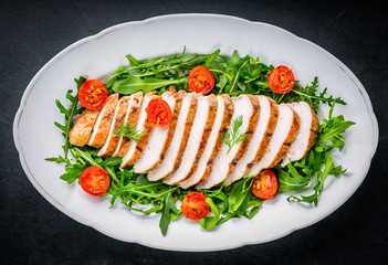 Grilled chicken breast served on lettuce with cherry tomatoes