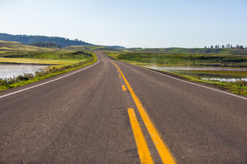 Fototapeta na wymiar An infinite road through the Lamar Valley in Yellowstone Nationa