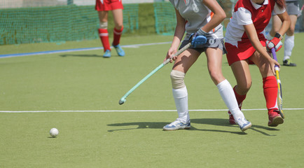 Women field hockey players with ball