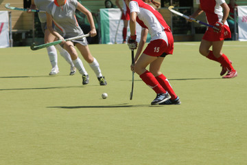 Women field hockey players with ball