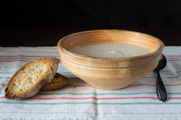 Mushroom soup puree in ceramic bowl with bread