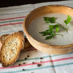Ceramic bowl with mushroom soup puree with bread