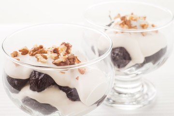 Dessert with prune, walnuts and whipped cream
