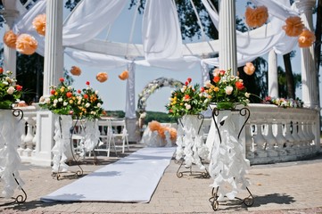 wedding arch with chairs and many flowers and decor