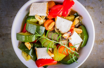 Tasty ratatouille made of zucchini, carrots, peppers and grilled chicken